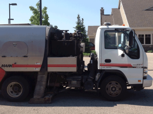 Street Sweeping Services in the Grand Rapids, Michigan area-image of street sweeper truck